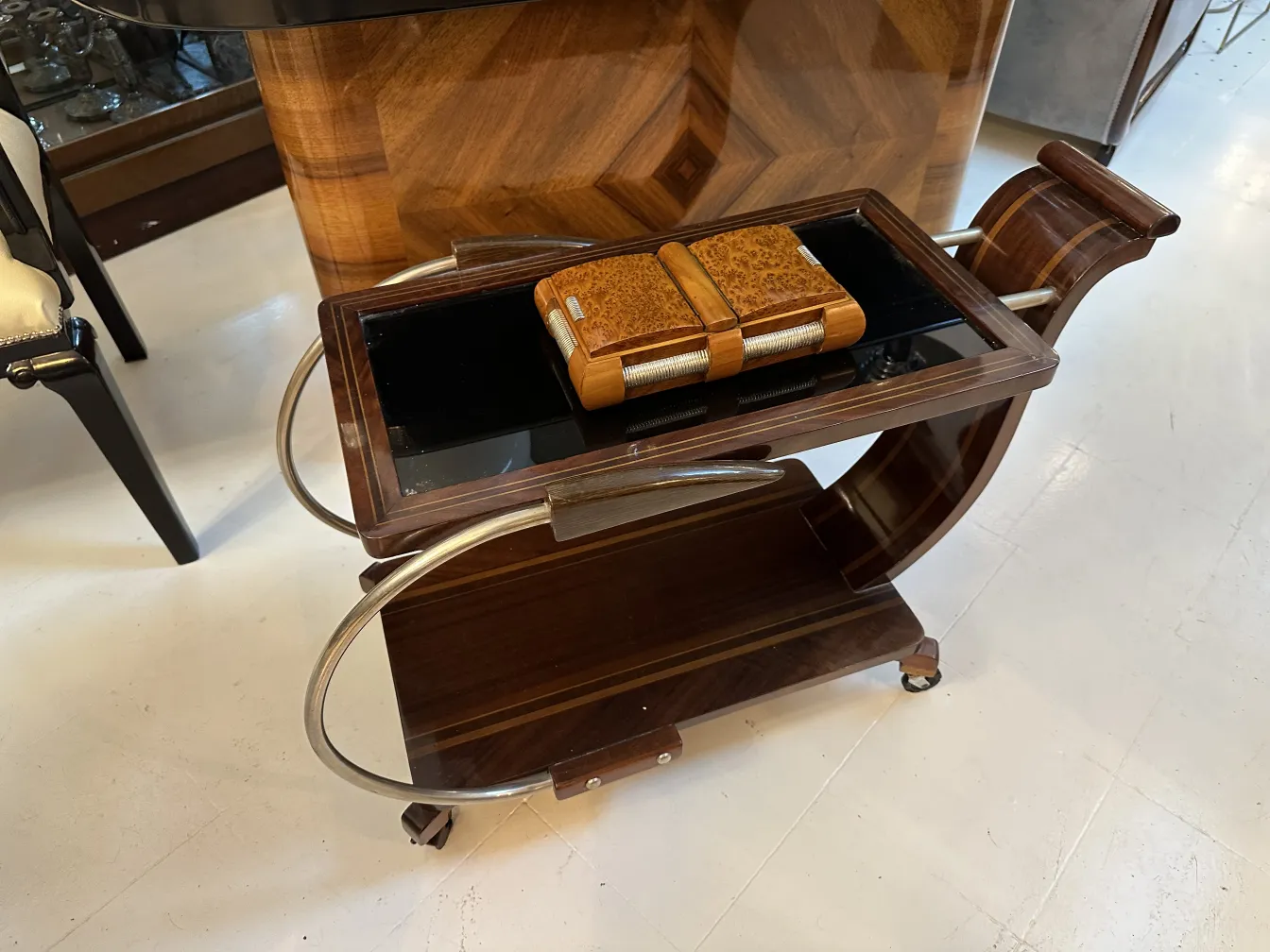 Antique wooden box on stylish cart with wheels