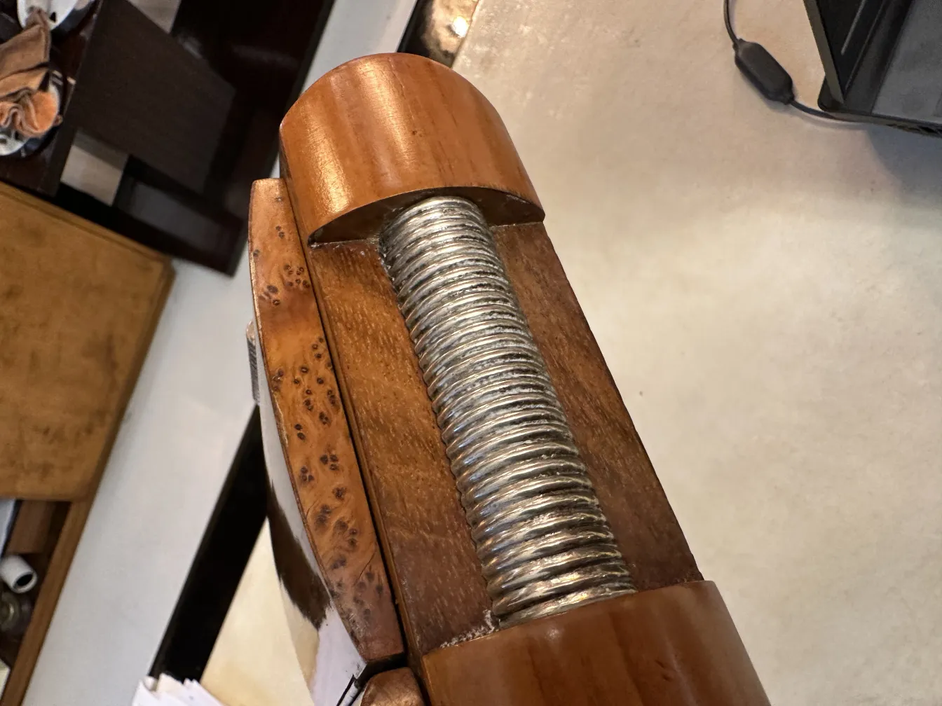 Top view of an antique wooden box with metal screws.