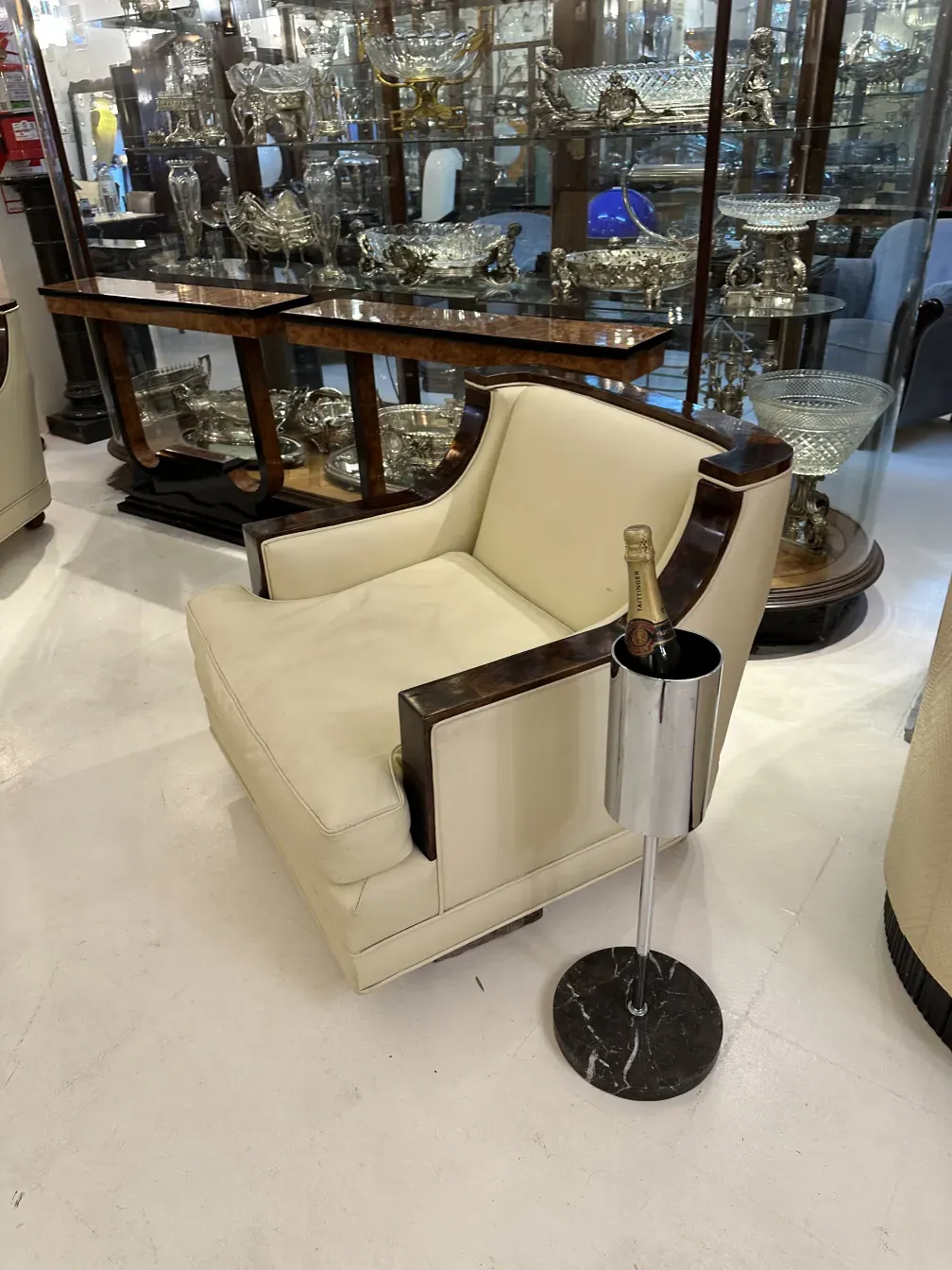 Antique champagne cooler with shiny finish beside a chair