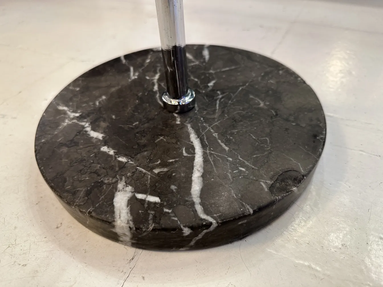 Antique champagne cooler with black marble base and elegant design.