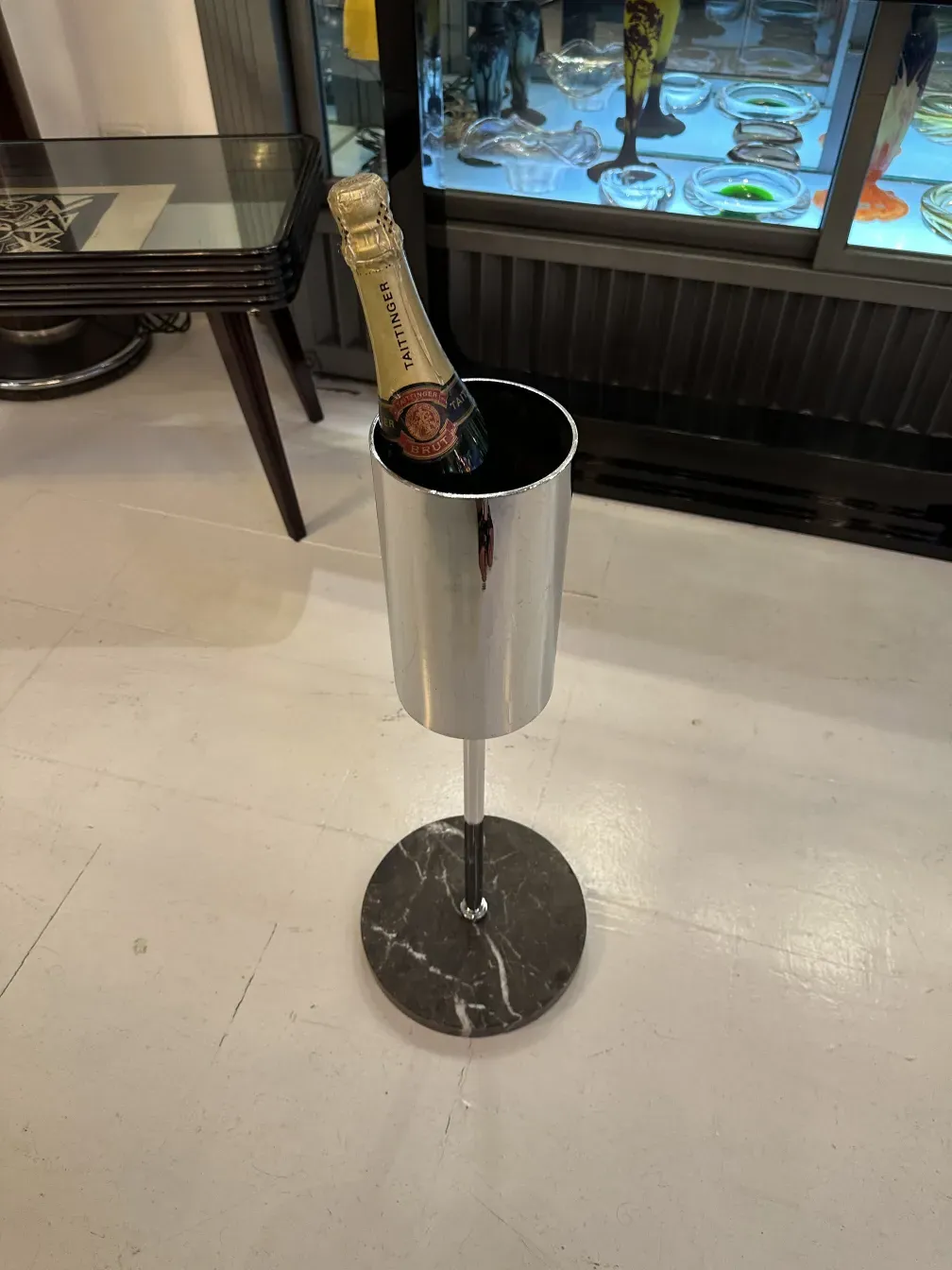 Champagne bottle in elegant cooler with black marble base.