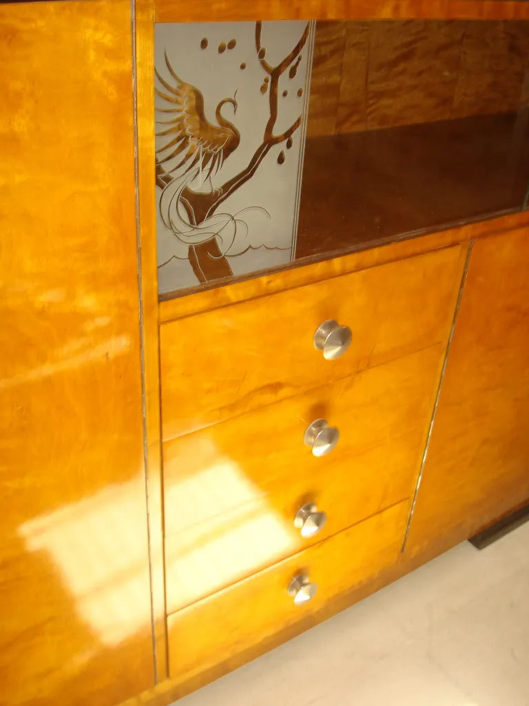 Antique sideboard featuring artistic design and three drawers.