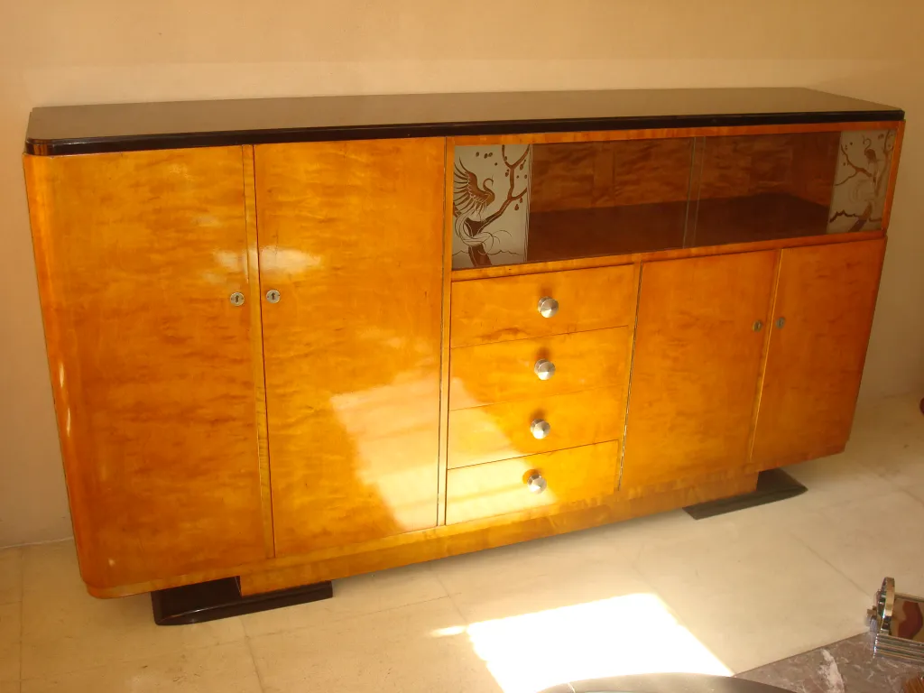 Antique sideboard with a shiny surface and unique details.