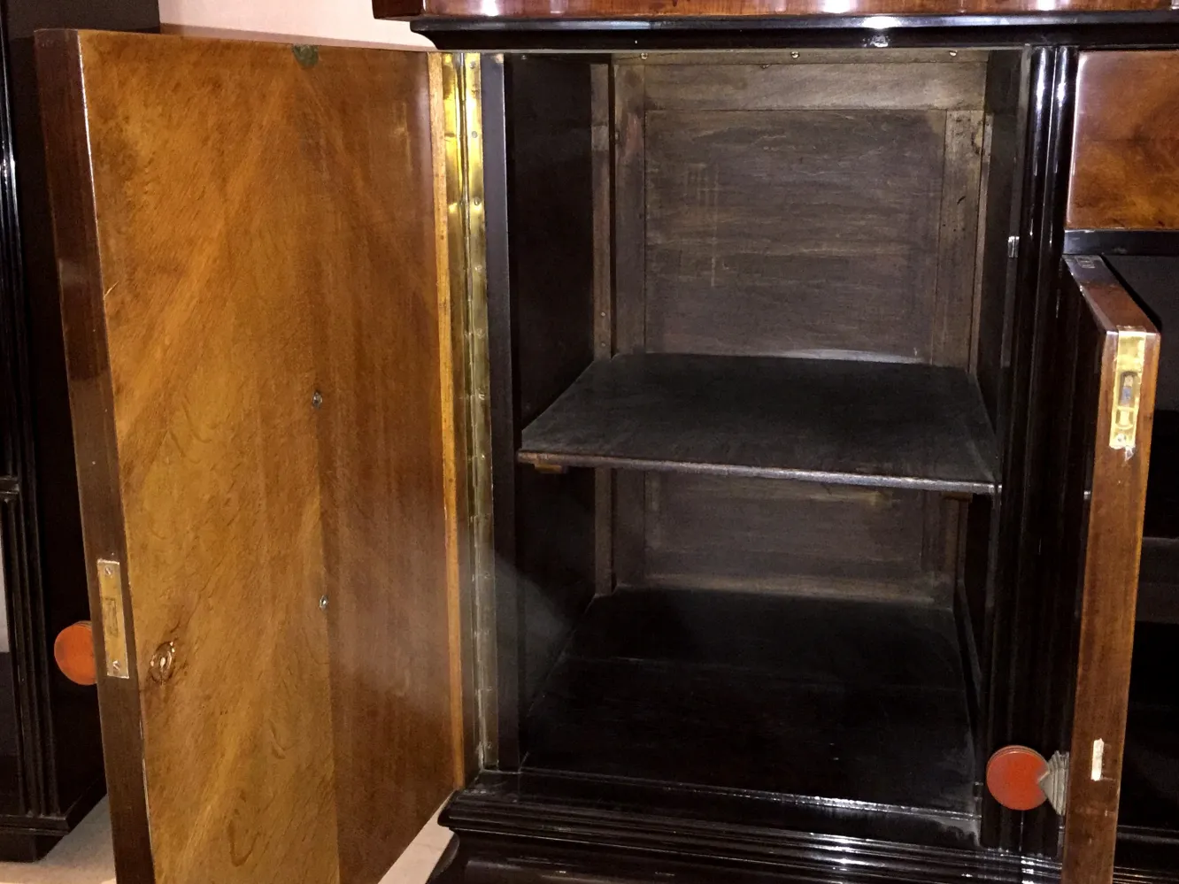 Antique sideboard with open doors and empty shelves.