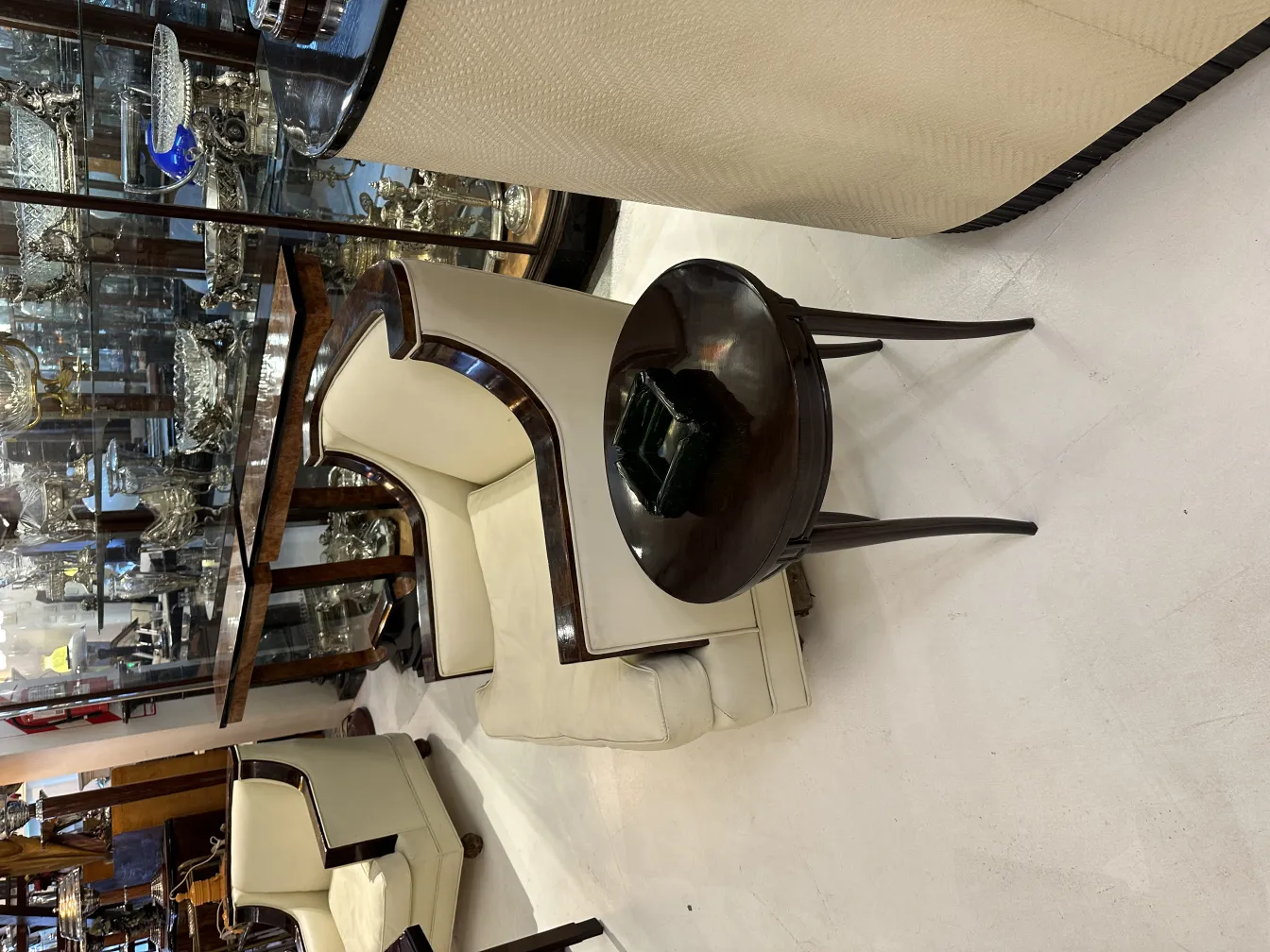 Antique standing ashtray in an vintage setting with elegant armchairs.