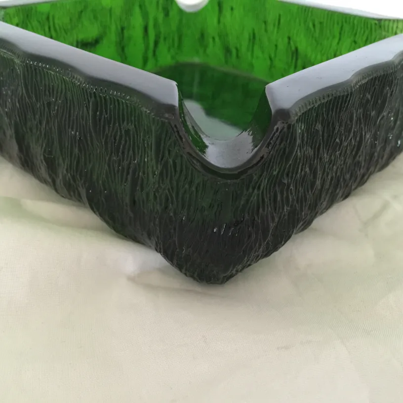 Antique standing ashtray in green with a textured surface