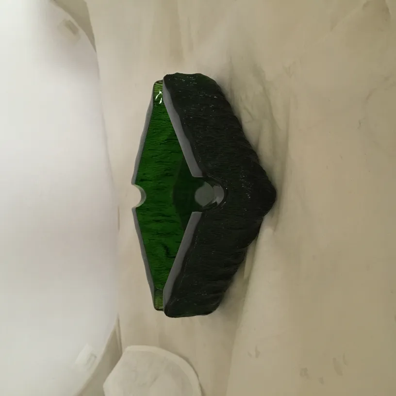 Antique green standing ashtray with an irregular shape suitable for decor.
