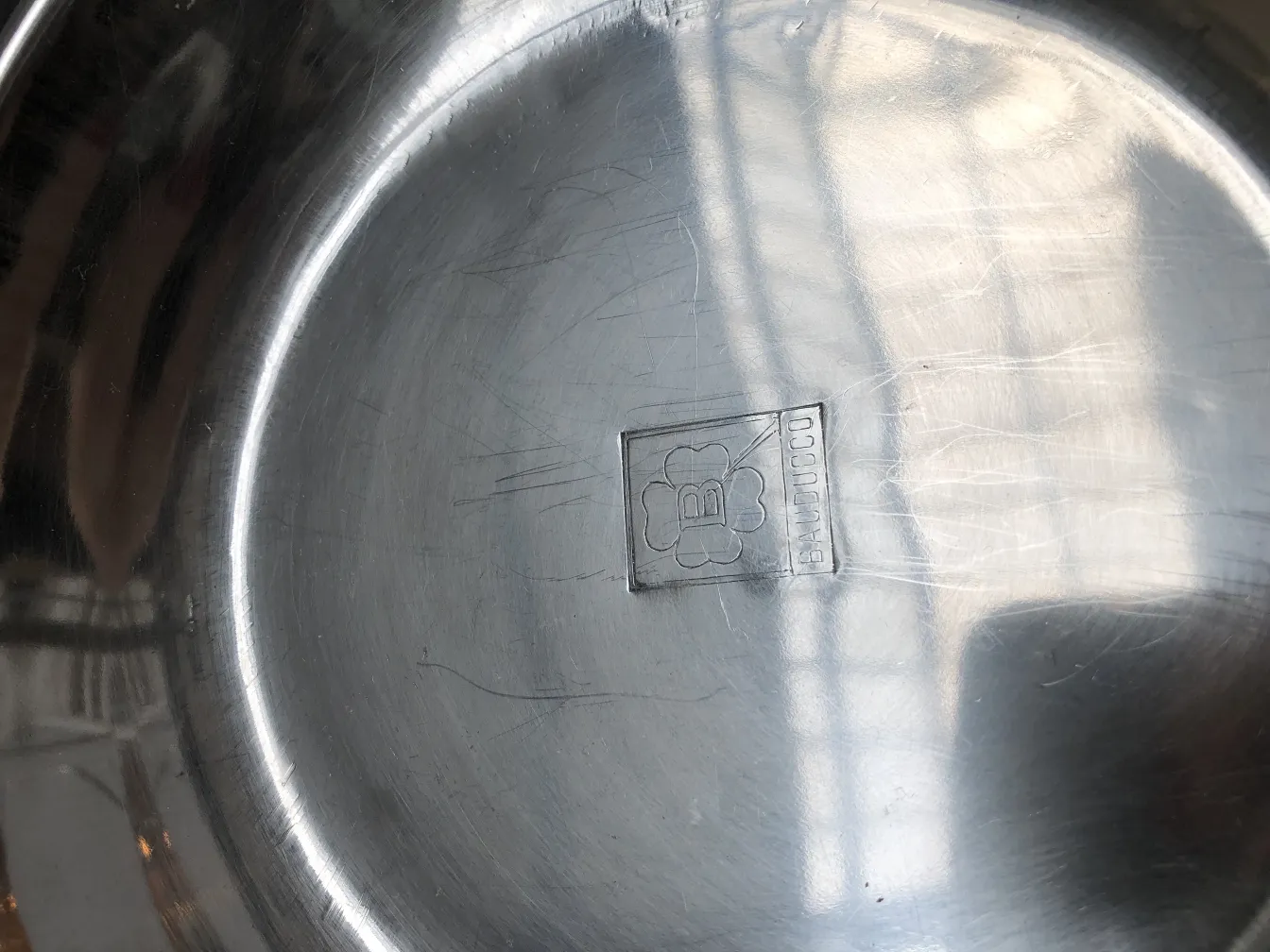 Shiny standing ashtray in minimalist setting with marking