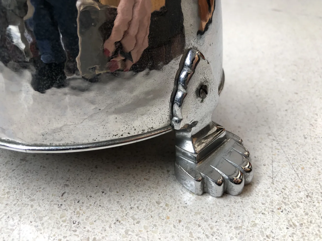 Antique standing ashtray with decorative details and foot