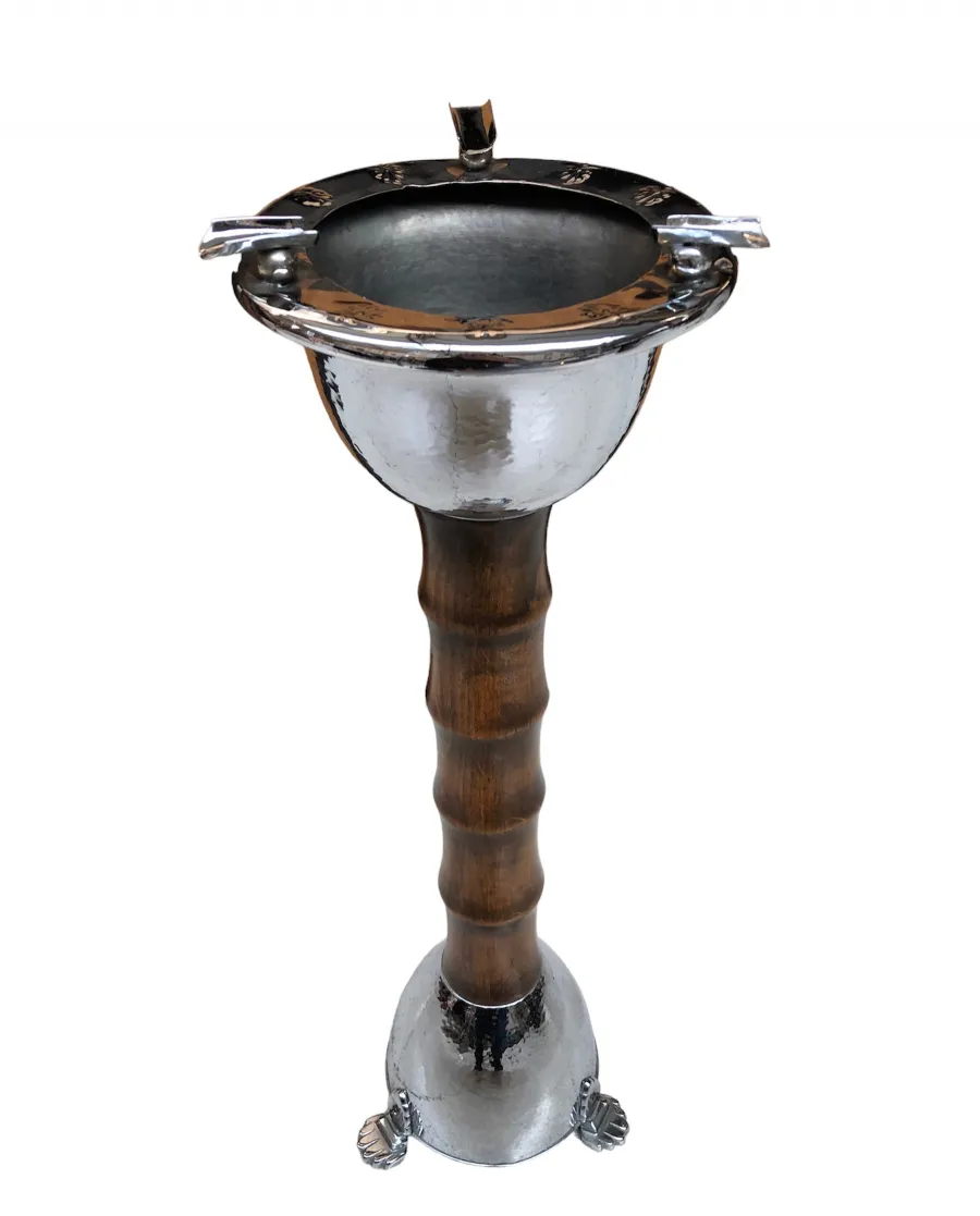 Standing ashtray with an antique design and intricate finishes in an appealing setting.