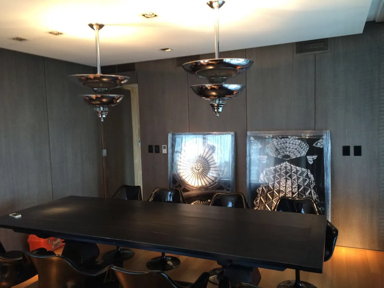 Interior featuring 2 antique hanging lamps and a large table