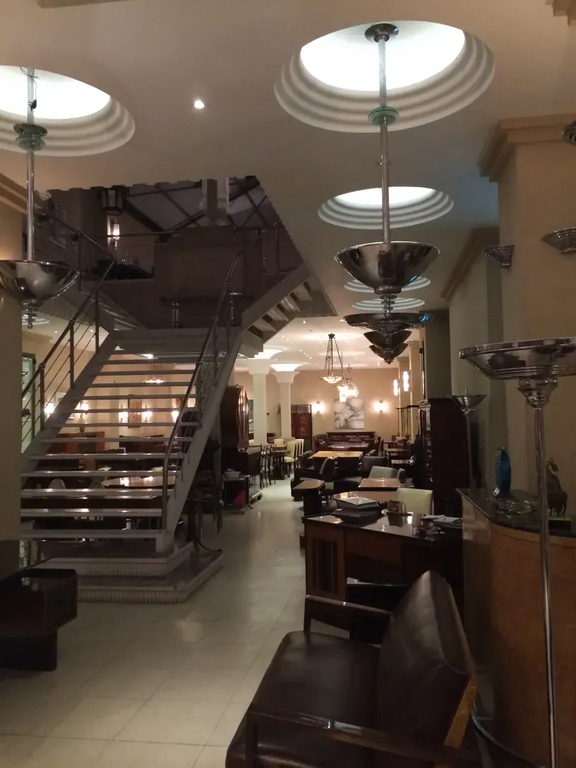 View of two antique hanging lamps in an elegant environment with various furniture.