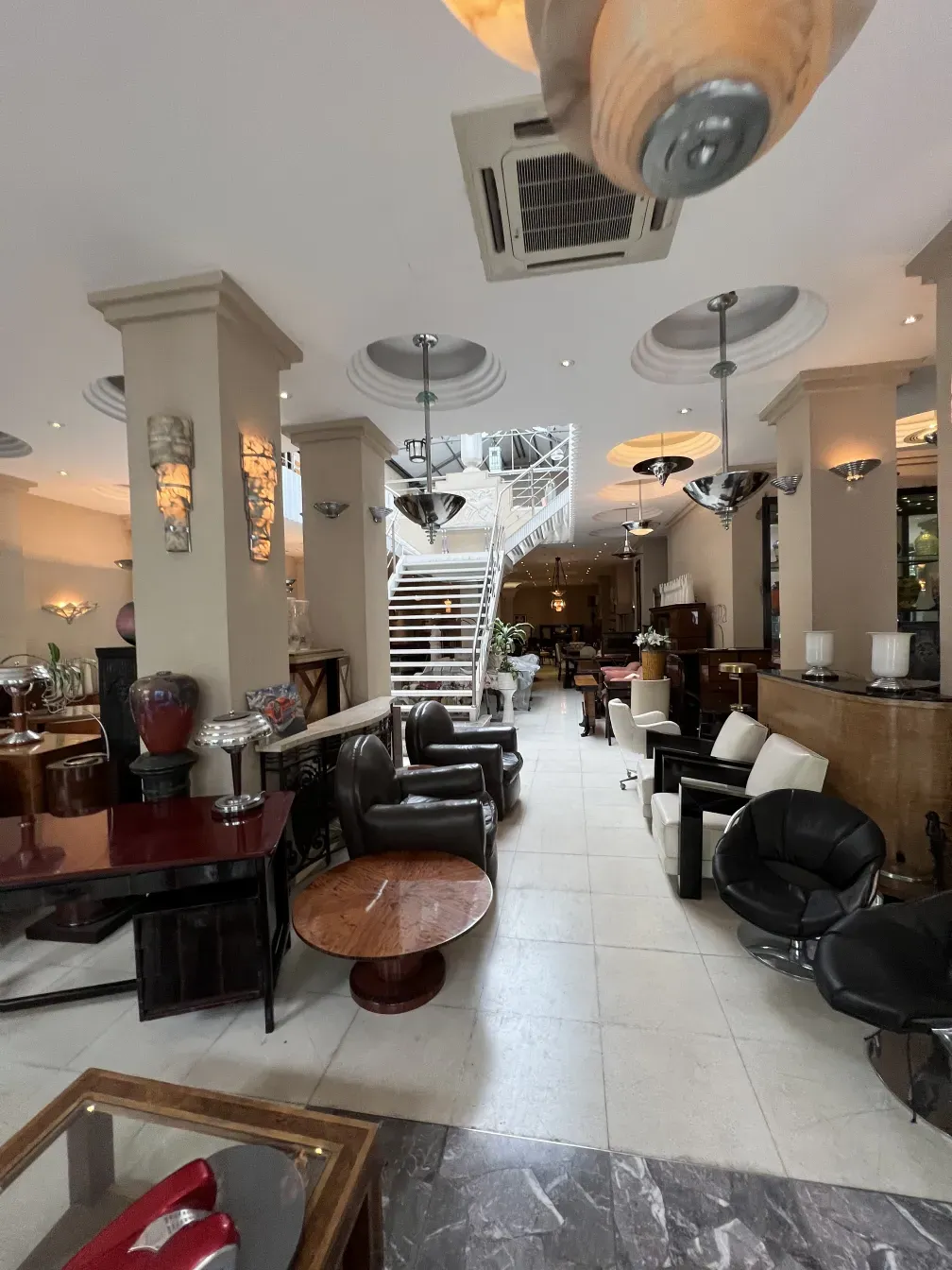 View of 2 antique hanging lamps in a cozy living room with elegant furniture.