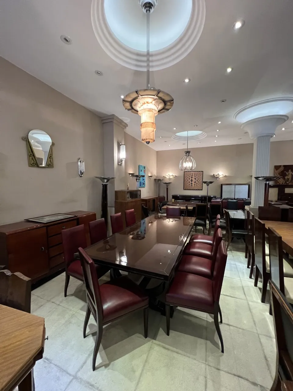 two antique hanging lamps in a spacious environment with tables and chairs