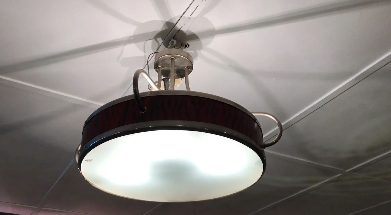 two antique hanging lamps with a unique design in a home setting