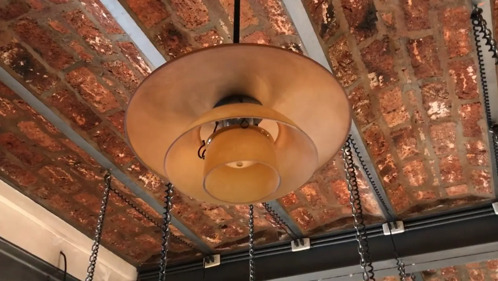 two antique hanging lamps in a rustic setting