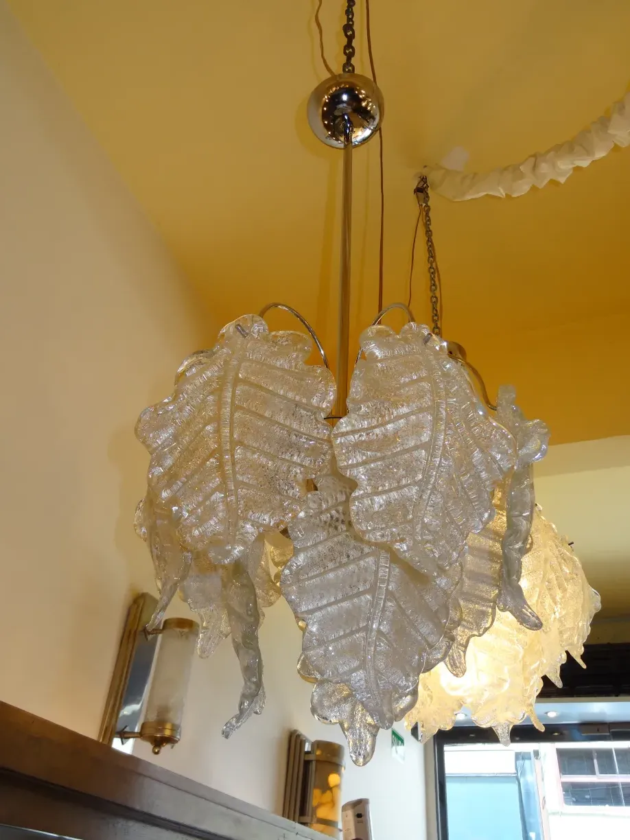 Two antique hanging lamps with leaf design, in a warm setting