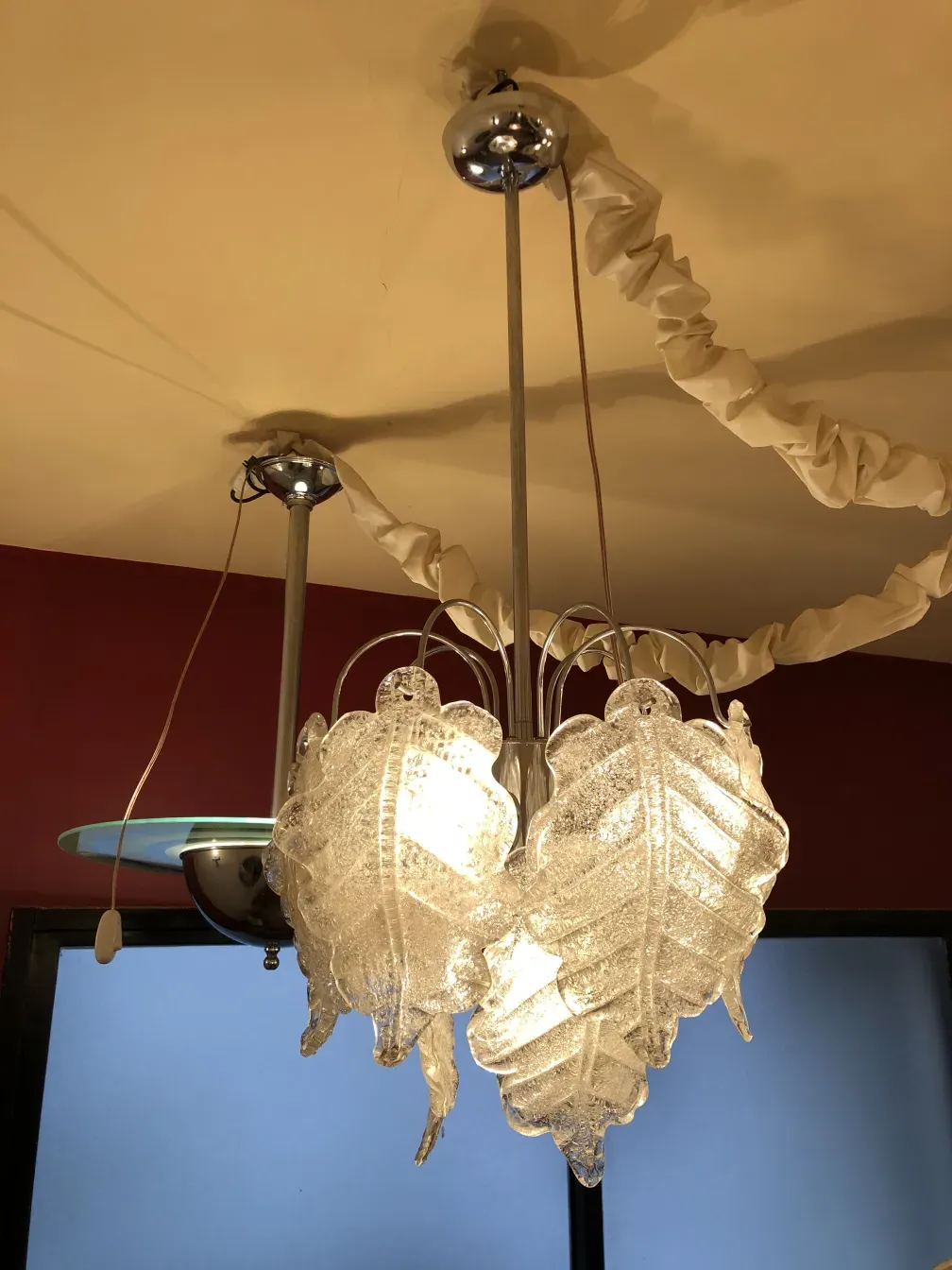 two antique hanging lamps with shine, decorated in a warm setting