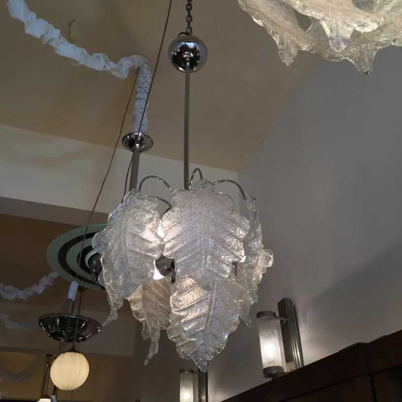 two antique hanging lamps with leaf design illuminating a room