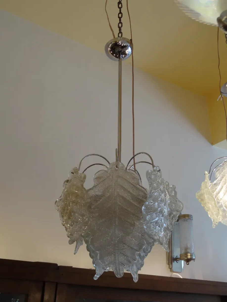 2 antique hanging lamps with leaf design, illuminating a cozy space.
