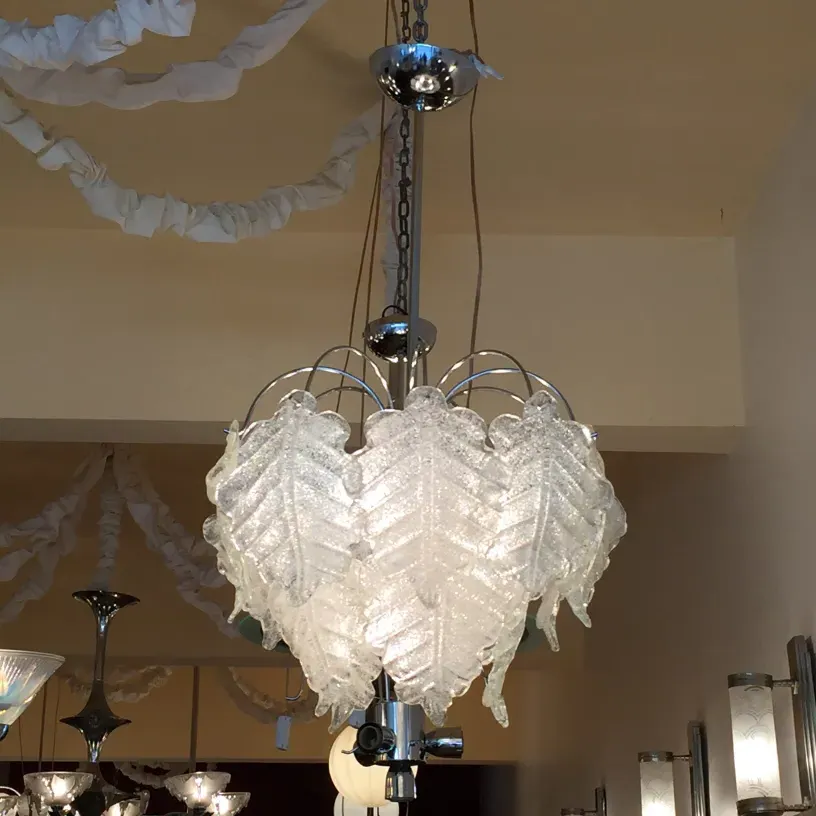 2 antique hanging lamps with leaf design, in a cozy setting