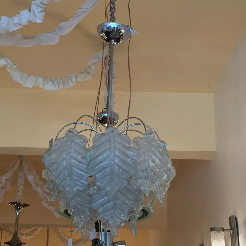 two antique hanging lamps with decorative details in a neutral setting