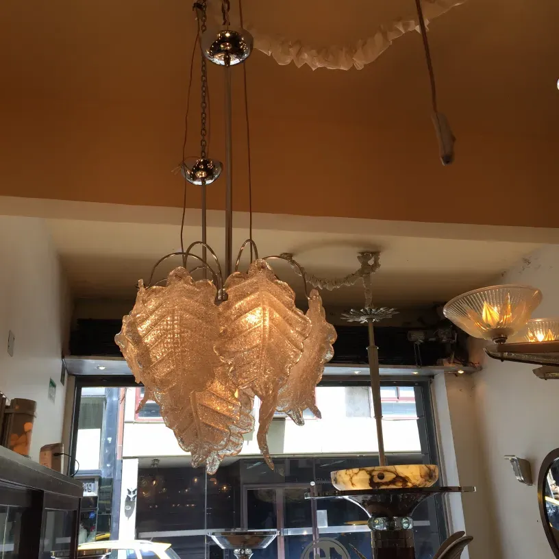 Two antique hanging lamps with intricate details in a cozy setting.