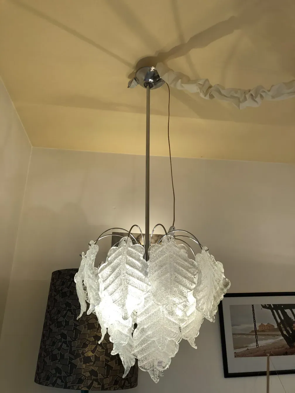 Antique hanging lamp with bright leaf design and warm atmosphere.