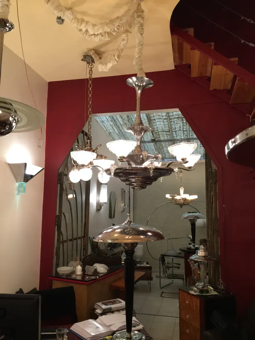 Two elegant antique hanging lamps illuminating a room. Colorful background and classic furniture.