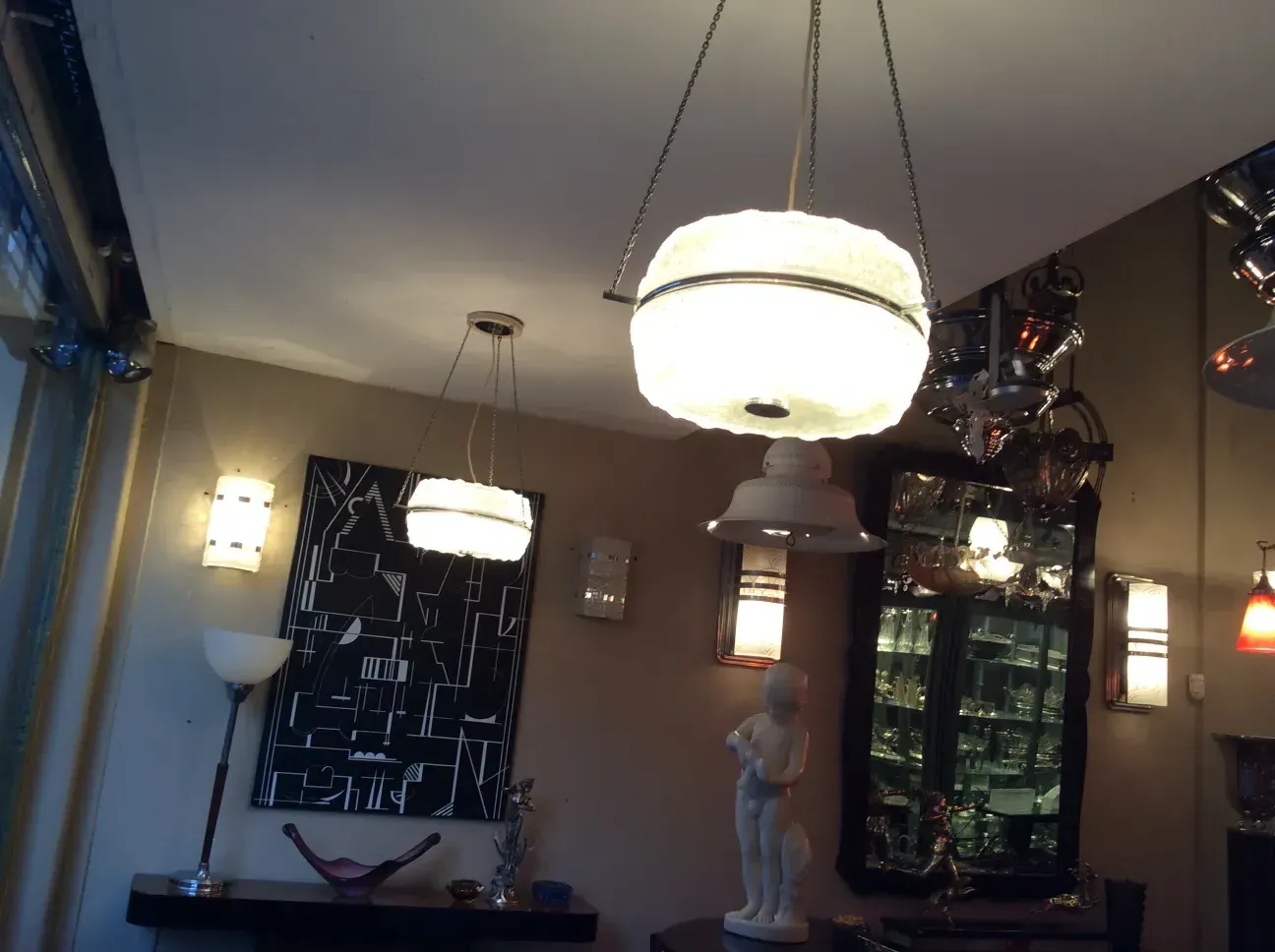 Two antique hanging lamps illuminating a room.