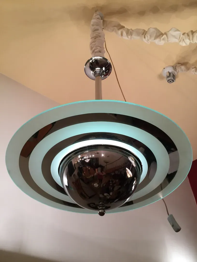 Top view of 2 antique hanging lamps with decorative details and a soft background