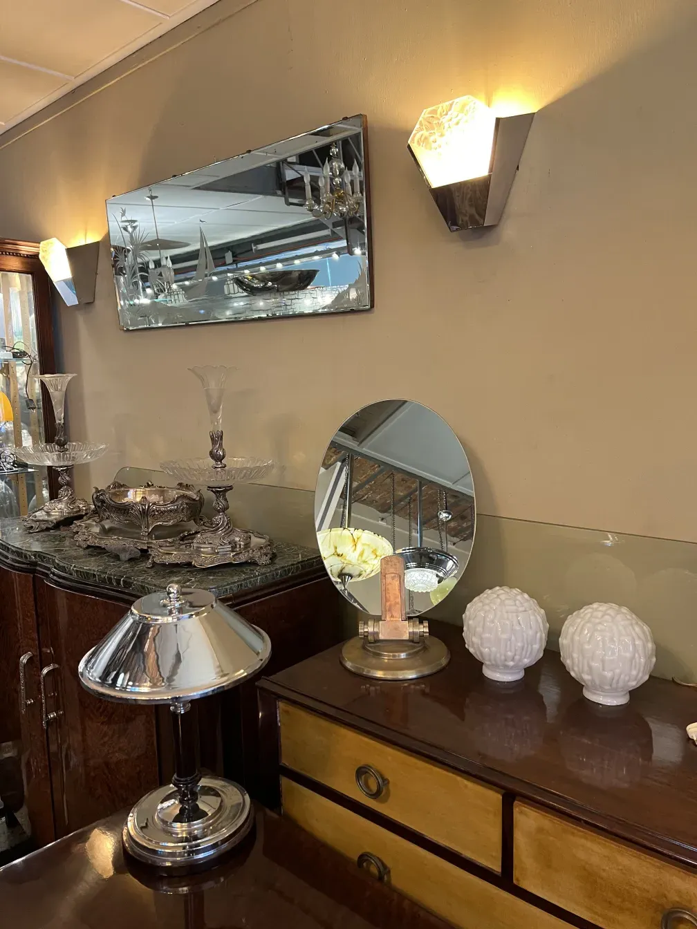 antique decorative mirror on a table with other items