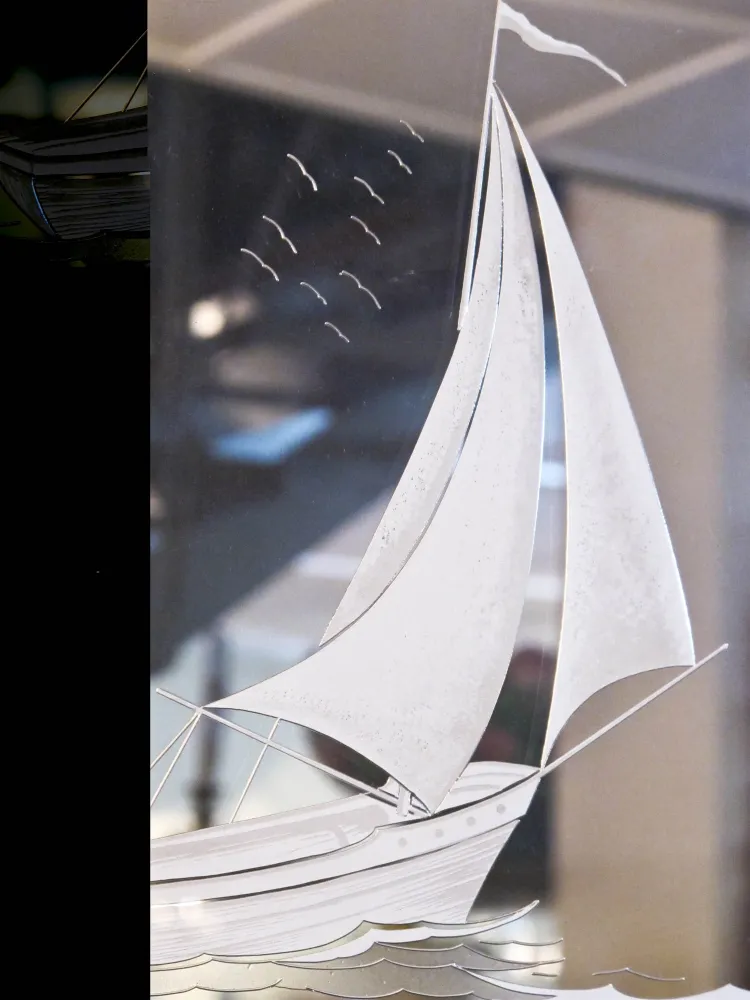 antique mirror reflecting a boat and waves
