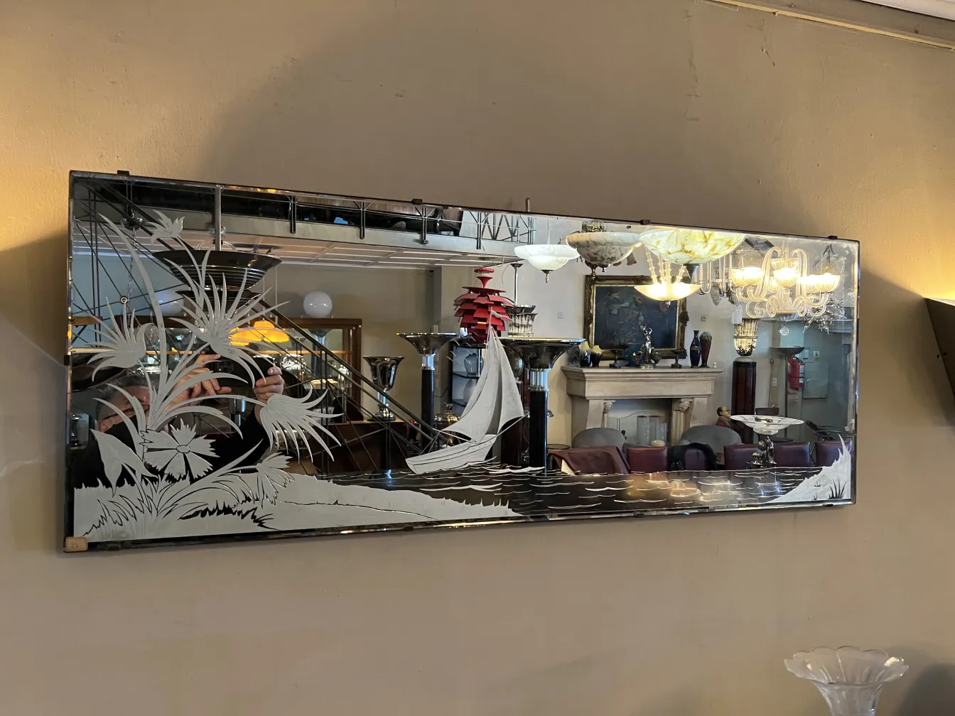 Antique mirror with floral design, elegant and classic setting.
