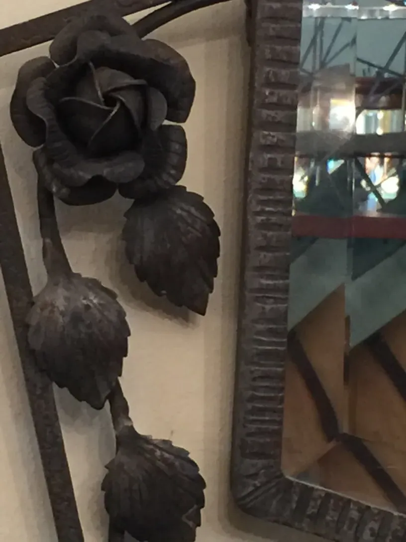Antique mirror decorated with a metal rose