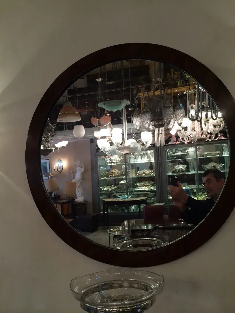 antique round mirror with decorative surroundings