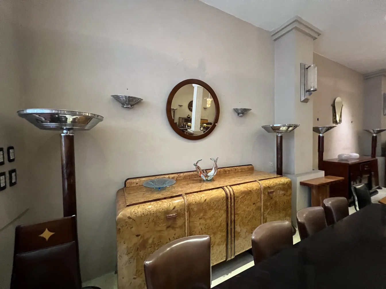 antique round mirror on the wall with decor