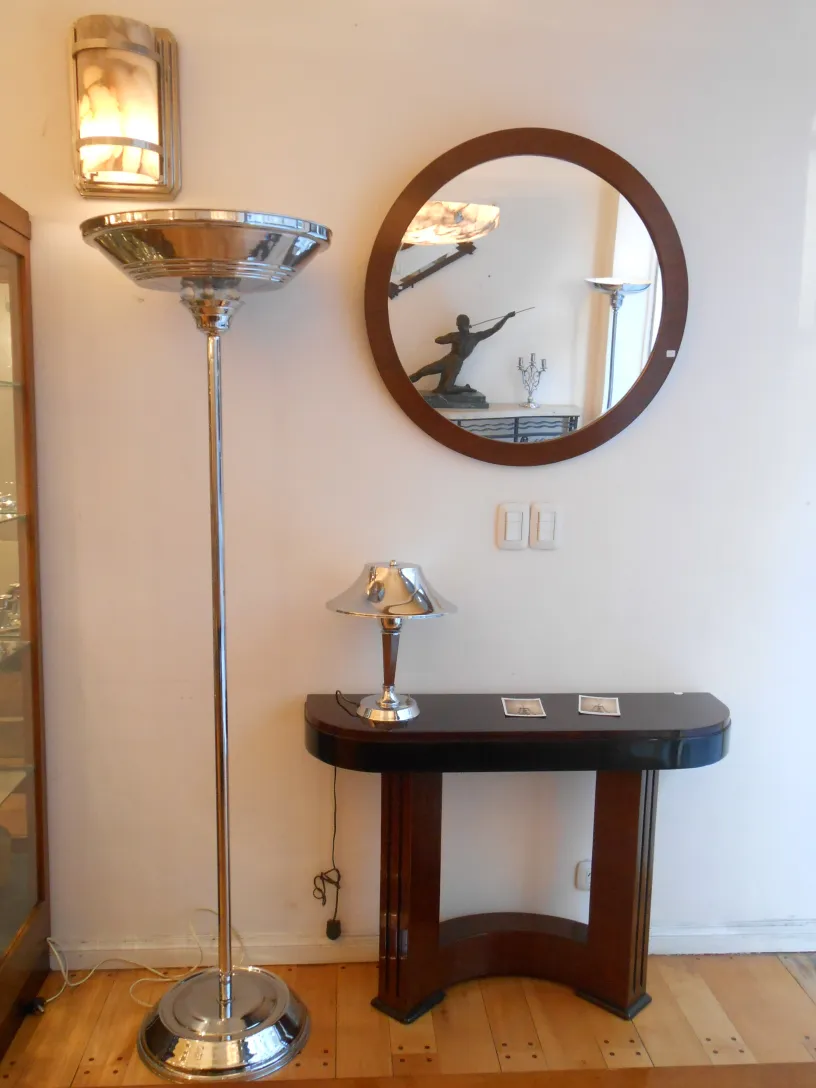 antique round mirror hanging on the wall