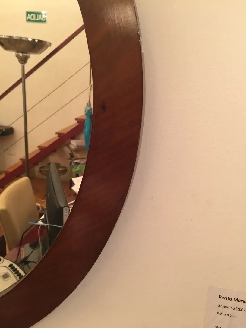 Antique decorative mirror in an indoor setting with soft lighting details.