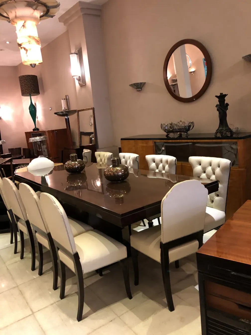 antique round mirror on the wall with elegant furniture