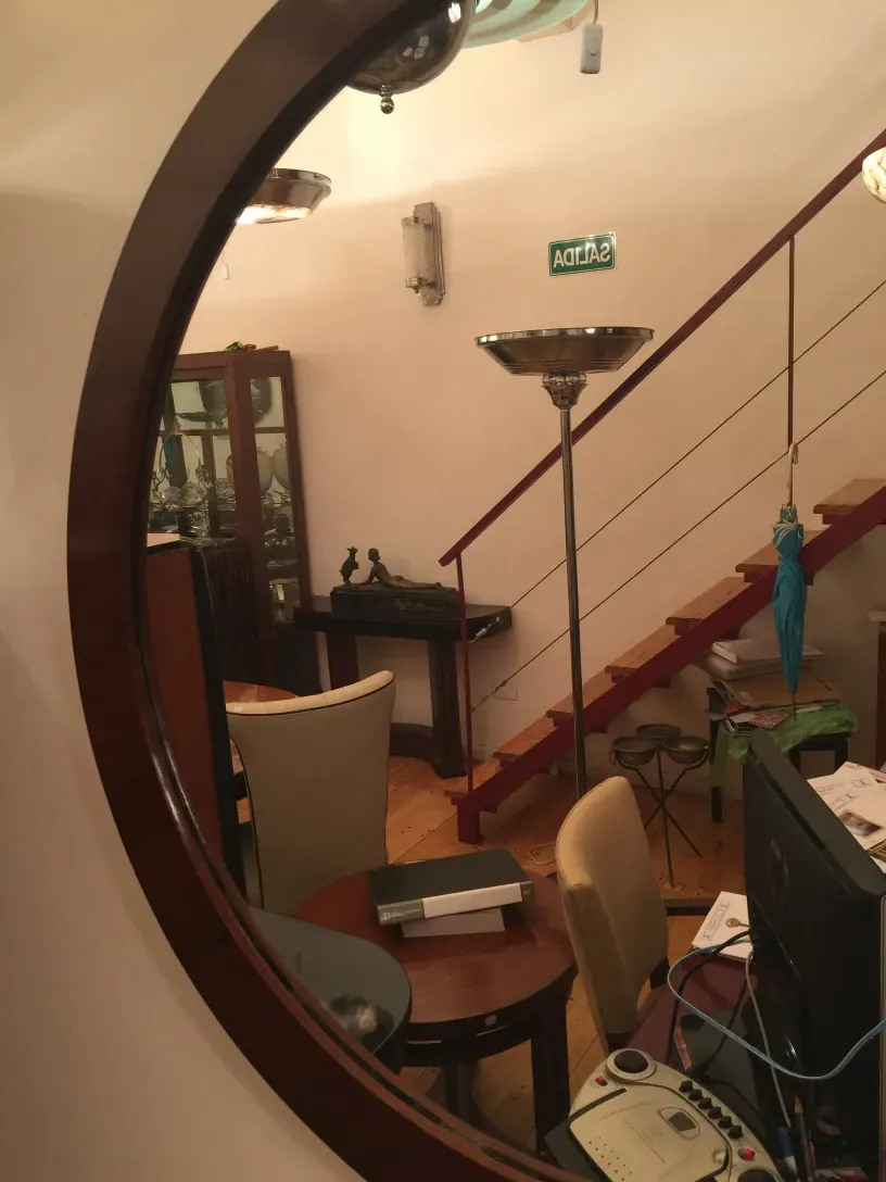 antique mirror with rounded design, decorated room