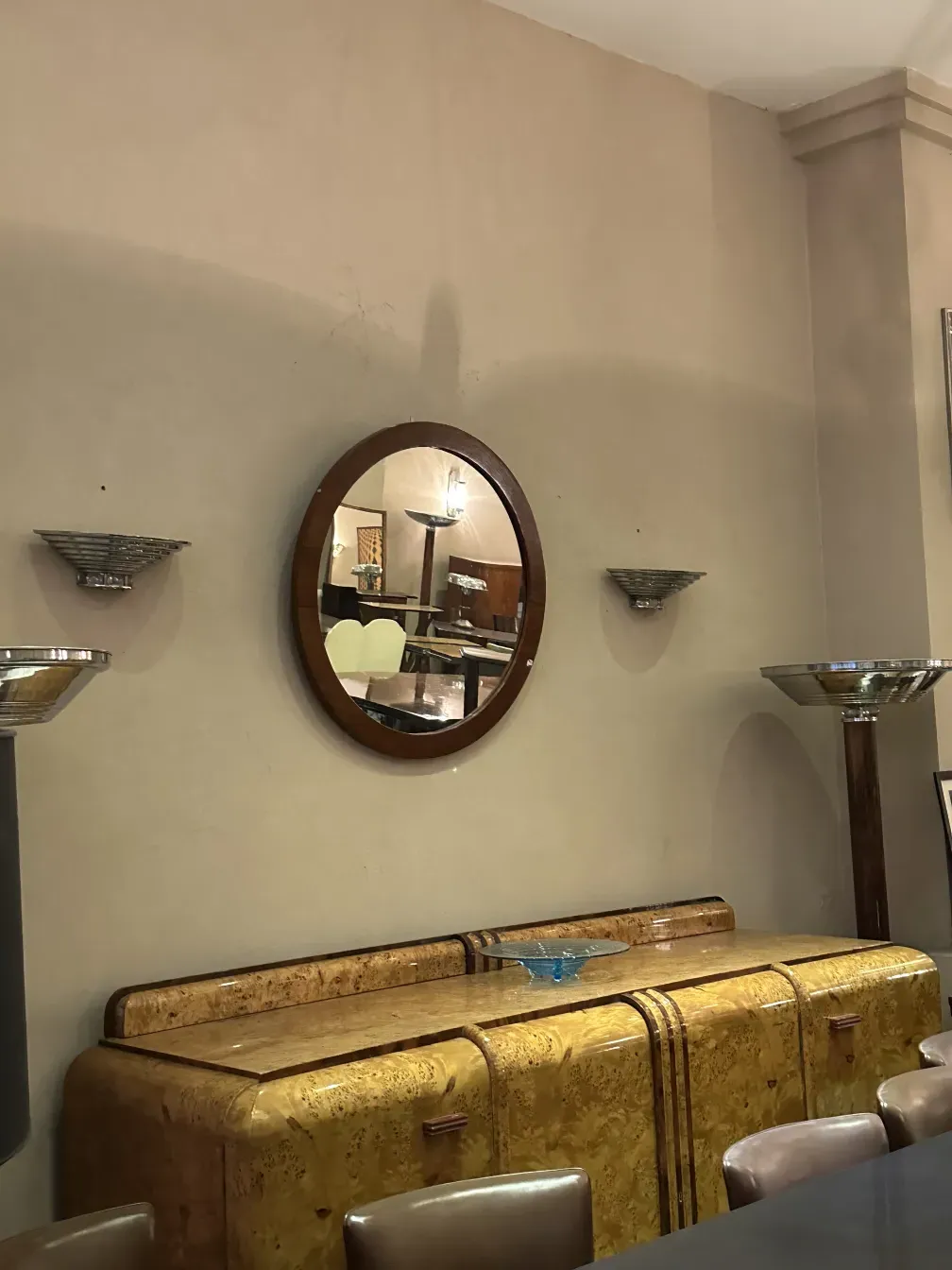 antique mirror with a round frame on a decorative wall