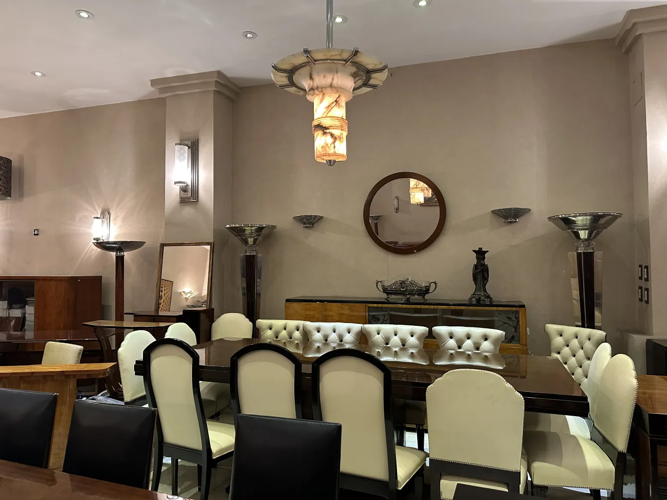 antique mirror in an elegant setting with tables and chairs