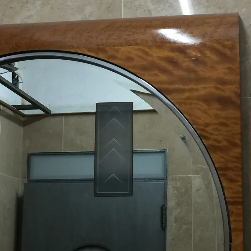antique mirror with arched frame in a modern setting