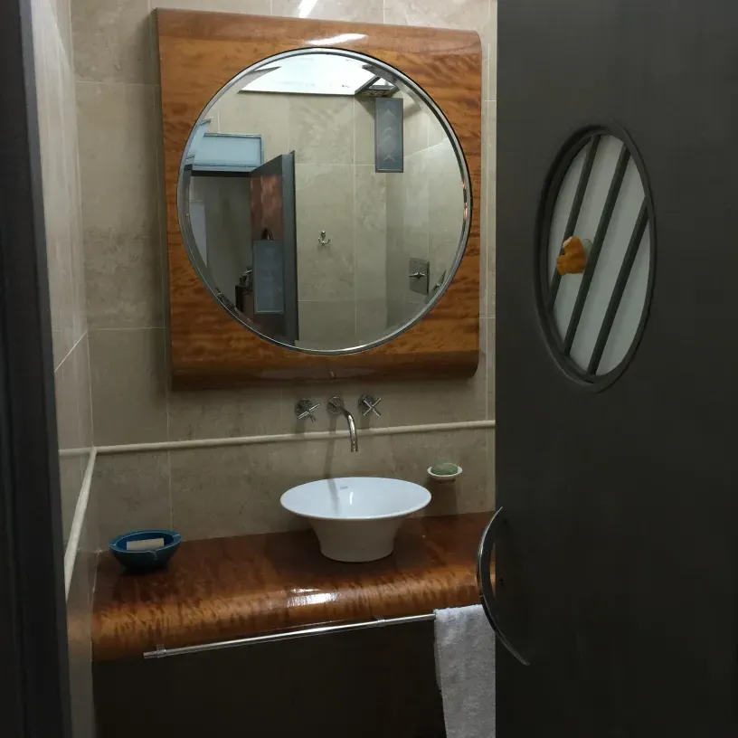 antique round mirror in bathroom, with water splash