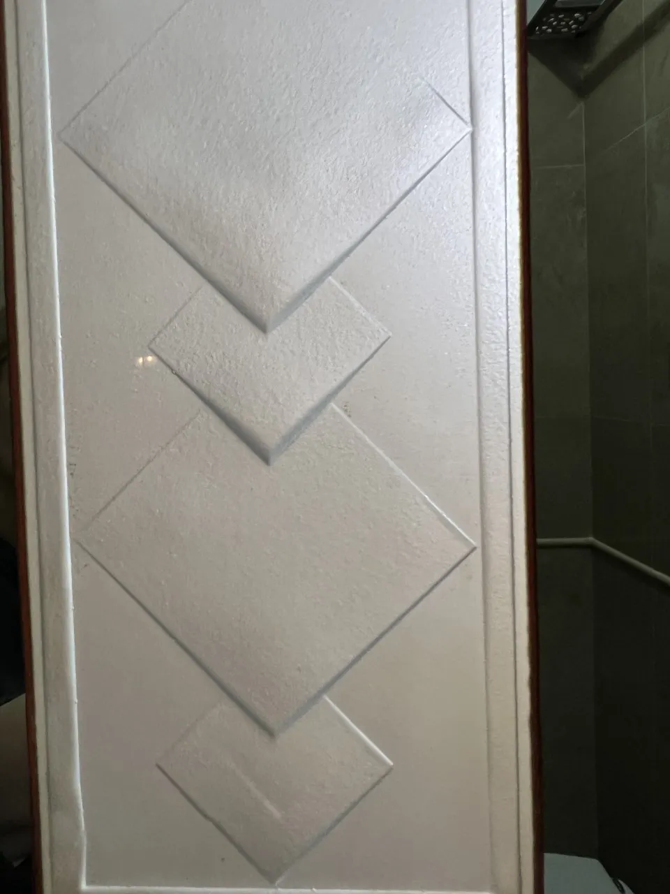 antique wall mirror decorated with geometric shapes and white background