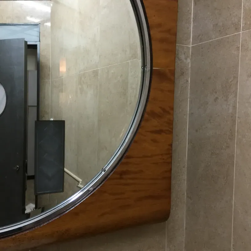 Antique round mirror with a clear edge in a modern setting.