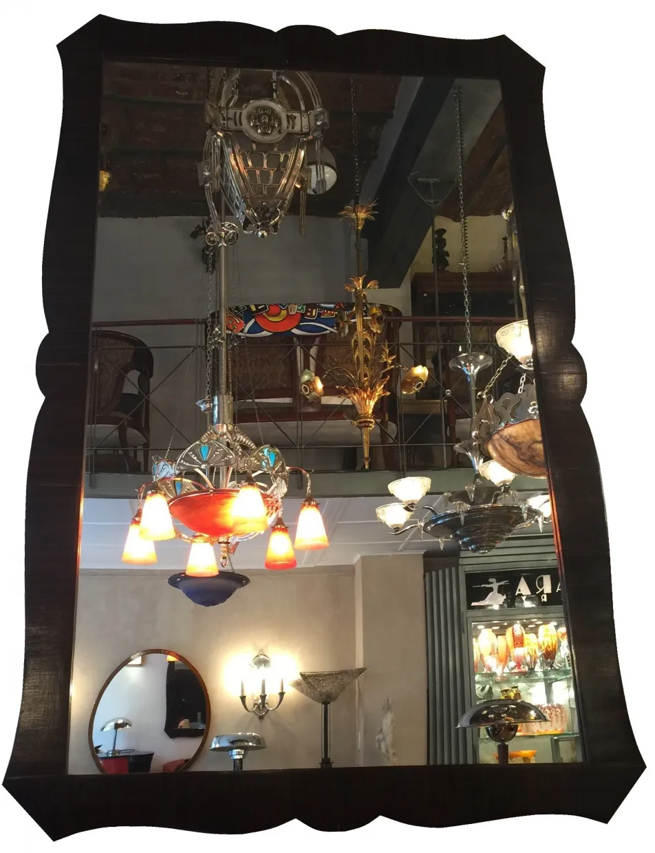 antique mirror with decorative edges and hanging lights