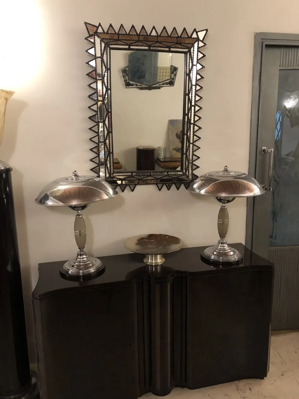 antique mirror with decorative frame and two lamps