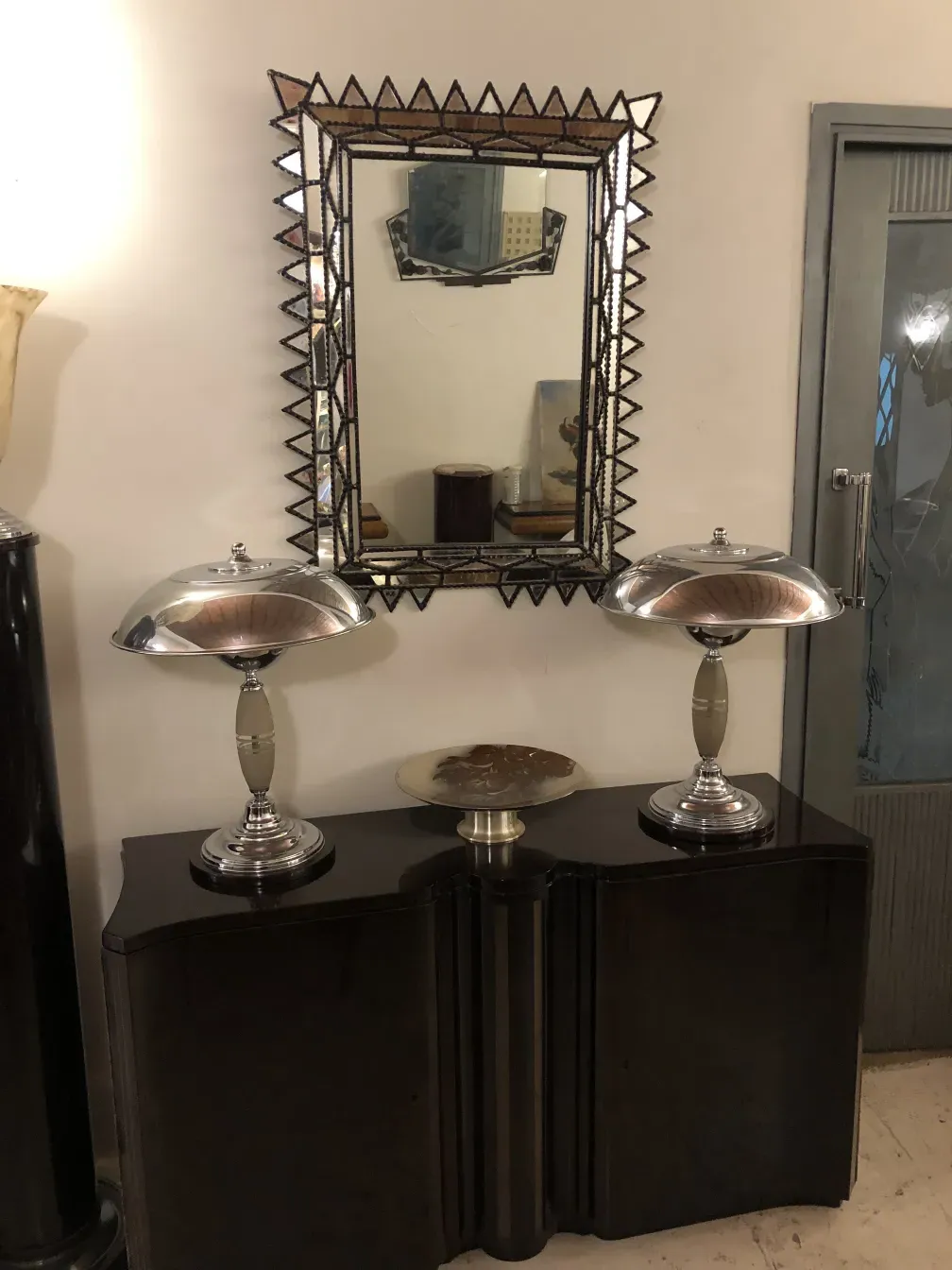 antique mirror with beveling and detailed decoration in an elegant room